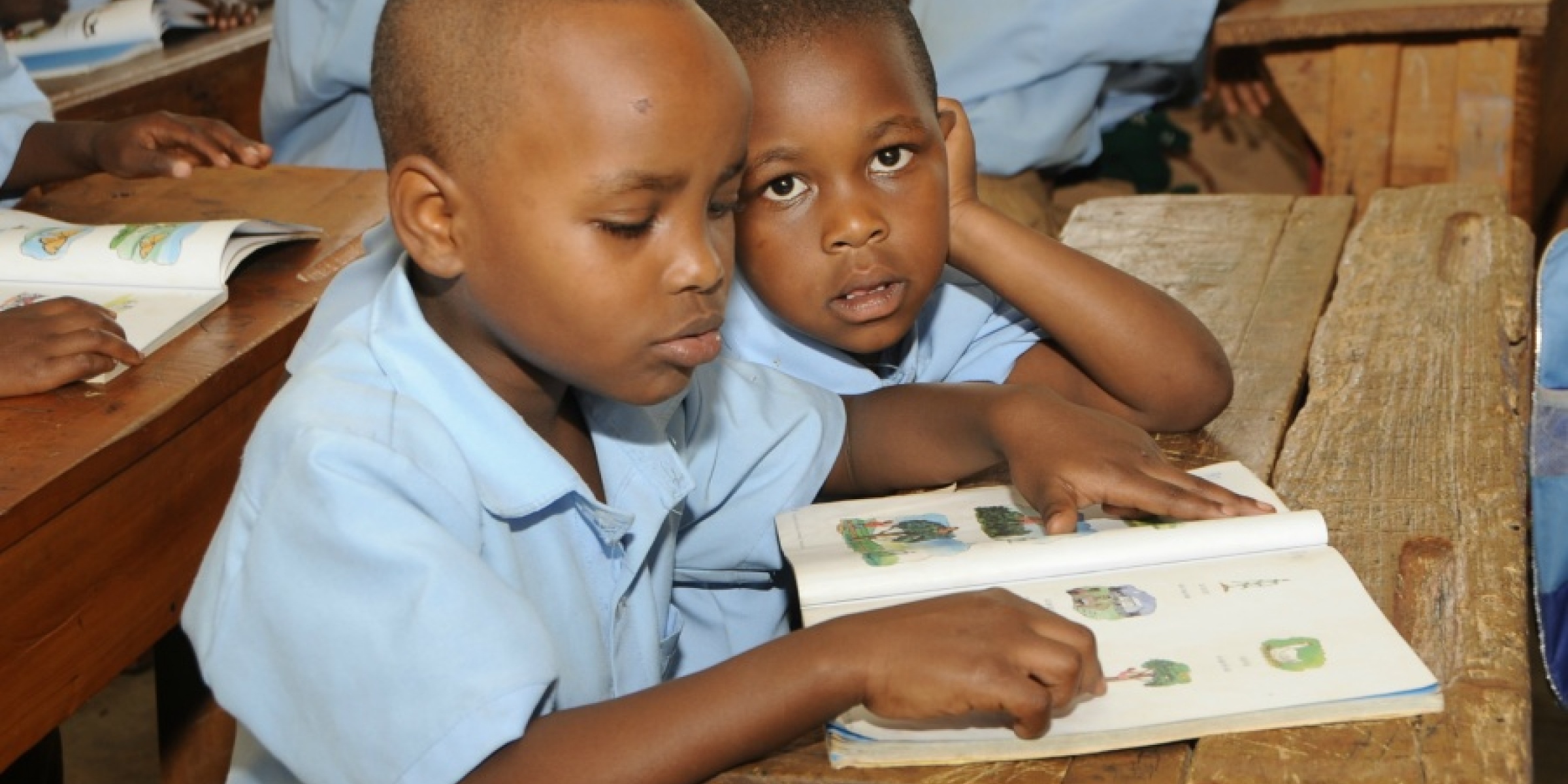 A boy and his classmate learn to read. Rwanda. Credit: GPE