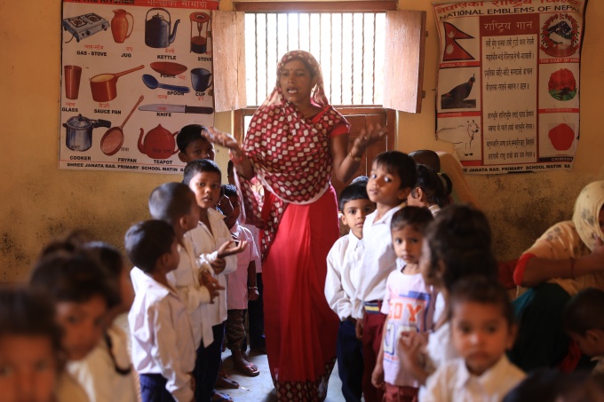 students being taught by a teacher at the Shree Janata Rashtriya Primary School in Bode Barsain Municipality in Saptari District in Nepal's southern plain. Credit: UNICEF/UNI448516/Laxmi-Prasad-Ngakhusi